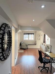 a living room with a table and a chair at Cozy Lovely Ravine facing Suite. in Mississauga