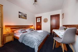 a bedroom with a bed and a desk and a chair at Willa Bartek in Zakopane +47 photos