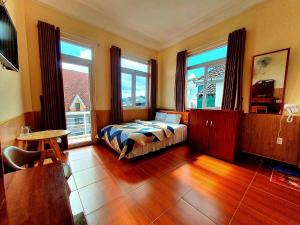 Postel nebo postele na pokoji v ubytování Đông Đức Hostel Đà Lạt