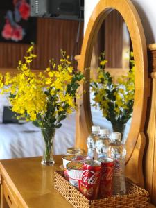 a table with coca cola bottles on a table with flowers at KHÁNH AN HOTEL in Da Lat