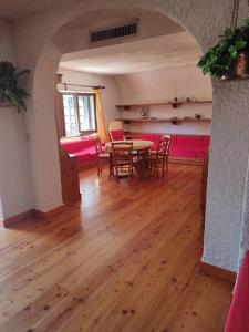 a room with a table and chairs and a wooden floor at Chalet Edelweiss Marsia-Tagliacozzo 1500mt in Marsia