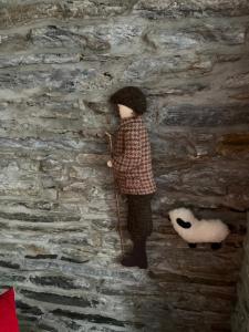 a doll standing next to a wall with a stuffed animal at Lower Thura House in Wick