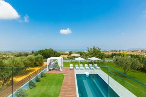 an image of a swimming pool on the roof of a house at Vilana Exclusive Villas in Skouloúfia