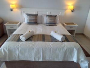 a white bed with two pillows on top of it at Brookes Hill Suites 238 in Port Elizabeth +24 photos
