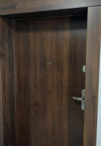 a wooden door with a handle in a room at Apartament Karoliny 2 self check-in, parking in Rzeszów