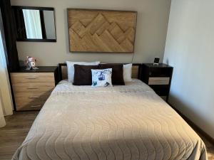 a bedroom with a large bed with two pillows at Borovets Gardens Studio Raya in Borovets