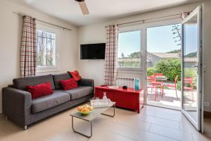 a living room with a couch and a table at Les appartements de l'Helios - Ile des Embiez in Six-Fours-les-Plages