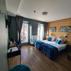 Łóżko lub łóżka w pokoju w obiekcie Le Grand Hotel