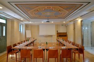 a large meeting room with a long table and chairs at Athenaeum Eridanus Luxury Hotel in Athens +101 photos
