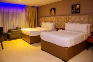 Postel nebo postele na pokoji v ubytování Boulevard Owerri Hotel