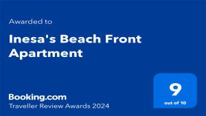 a blue sign with the words inciasas beach front appointment at Hanioti Beach Front Apartments in Hanioti