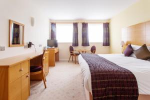 a hotel room with a bed and a desk at George Albert Hotel & Spa in Dorchester