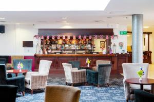 a restaurant with tables and chairs and a bar at George Albert Hotel & Spa in Dorchester