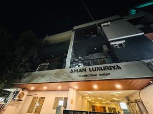 a building with a sign that reads amaan library sr affiliated monk at Home Escape 1BHK Apartment Near Bombay Hospital in Indore