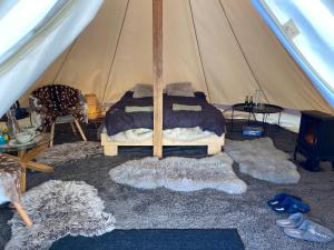 a bedroom with a bed in a tent at A Romantic & Luxurious stay in the nature of Karula National Park. in Ähijärve