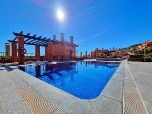 a swimming pool in front of a house at Oasis de Lujo Frente al Mar - by Aloha Palma in Águilas