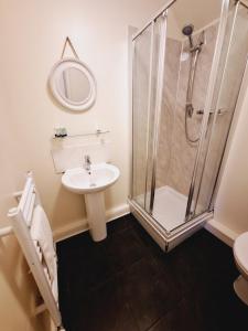 a bathroom with a shower and a sink at The First & Last Inn in Eyemouth