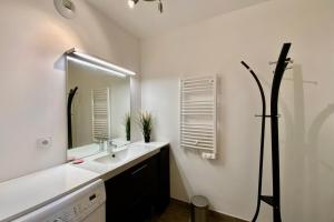 a bathroom with a sink and a mirror at Le Strada- Terrace and central position! in Montpellier