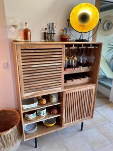 a wooden cabinet filled with lots of food items at Le Port Camargue- 2 bedrooms and air-conditioned ! in Le Grau-du-Roi