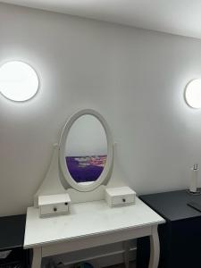 a mirror on top of a white table in a room at Captivating 1-Bed Apartment in London in London +5 photos