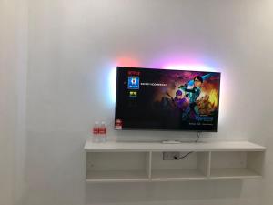 TV de pantalla plana en un estante blanco en SAMMY HOOMESTAY en Ipoh