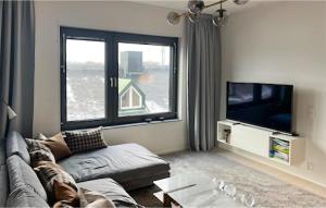 een woonkamer met een bank en een tv bij 2 Bedroom Gorgeous Apartment In Stockholm in Stockholm