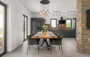 a dining room and kitchen with a table and chairs at Gorgeous Home In Buje With Wifi in Veli Vrh