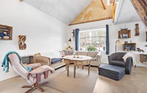a living room with a couch and a table at Gorgeous Home In Nørre Nebel With Sauna in Nørre Nebel