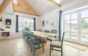 a dining room with a wooden table and chairs at Gorgeous Home In Nørre Nebel With Sauna in Nørre Nebel