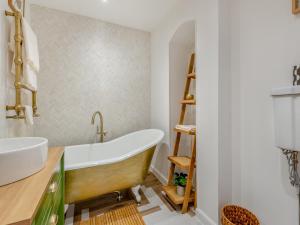 a bathroom with a tub and a sink at Wye View Cottage in Ross on Wye