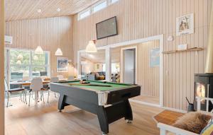 a living room with a pool table in it at Amazing Home In Ringkbing With 5 Bedrooms, Sauna And Wifi in Klegod
