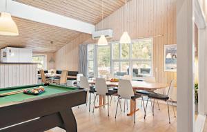 a kitchen and dining room with a pool table at Amazing Home In Ringkbing With 5 Bedrooms, Sauna And Wifi in Klegod