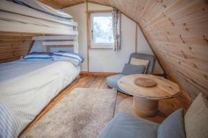 a bedroom with a bed and a table and chairs at The Pod - 1 Bedroom - Freshwest Beach Retreat in Pembroke