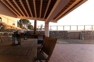 a patio with two chairs and a table with a roof at Casas Do Rio Sado - Sado River Country Retreat in Santa Margarida do Sado