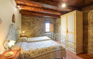 a bedroom with a bed and a stone wall at Awesome Home In Bibbiena With Kitchen in Bibbiena