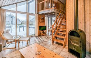a living room with a wood stove in a cabin at 3 Bedroom Gorgeous Apartment In Rechlin in Rechlin