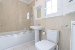 ein Badezimmer mit Toilette, Waschbecken und Badewanne in der Unterkunft The Old Bakery in Southwold + 8 Fotos