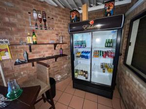 a drink refrigerator in a restaurant with a table at Edelweiss Corporate Guest House in Pretoria