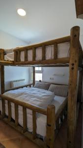 two wooden bunk beds in a room with at Apartamento Nievesol con 2 Parking y WiFi in Sierra Nevada