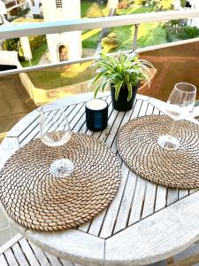 two baskets sitting on a table on a balcony at City Break Picquecailloux in Bordeaux