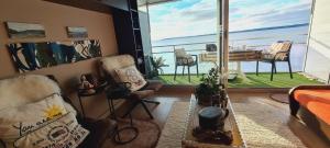 a living room with a view of the ocean at Studio les Trois Etoiles de Mer in Concarneau