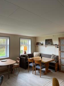 a living room with a couch and a table at Spacious apartment in beautiful Norway countryside close to trondheim fjord 