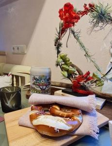 a table topped with a doughnut and a cup of coffee at Ferienwohnung Rose - b47219 in Peißenberg