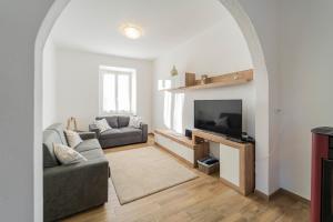 a living room with a couch and a television at 238 - Casa Al Mà, Vista MARE, Pace e Natura - PARCHEGGIO GRATIS INCLUSO in Sestri Levante