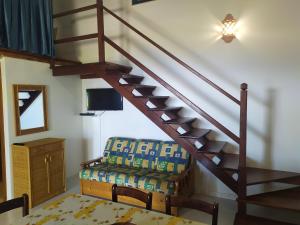 sala de estar con escalera y silla en Eoliando Case per Vacanze - Lipari, en Lipari