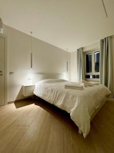 a bedroom with a large bed and a window at Luxury Apartment Togliatti in Rome
