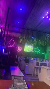 a room with a soccer game projected on a wall at Arena Guest House and Lounge in Ikeja