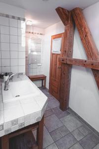 a bathroom with a sink and a wooden door at Dom Geologa in Marianówka +121 photos