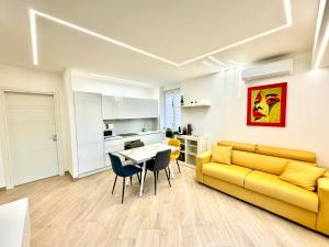 a living room with a yellow couch and a table at Luxury Apartment Togliatti in Rome