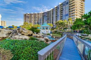 a walkway leading to a resort with a gazebo at Edgewater Tower 1-411 in Panama City Beach